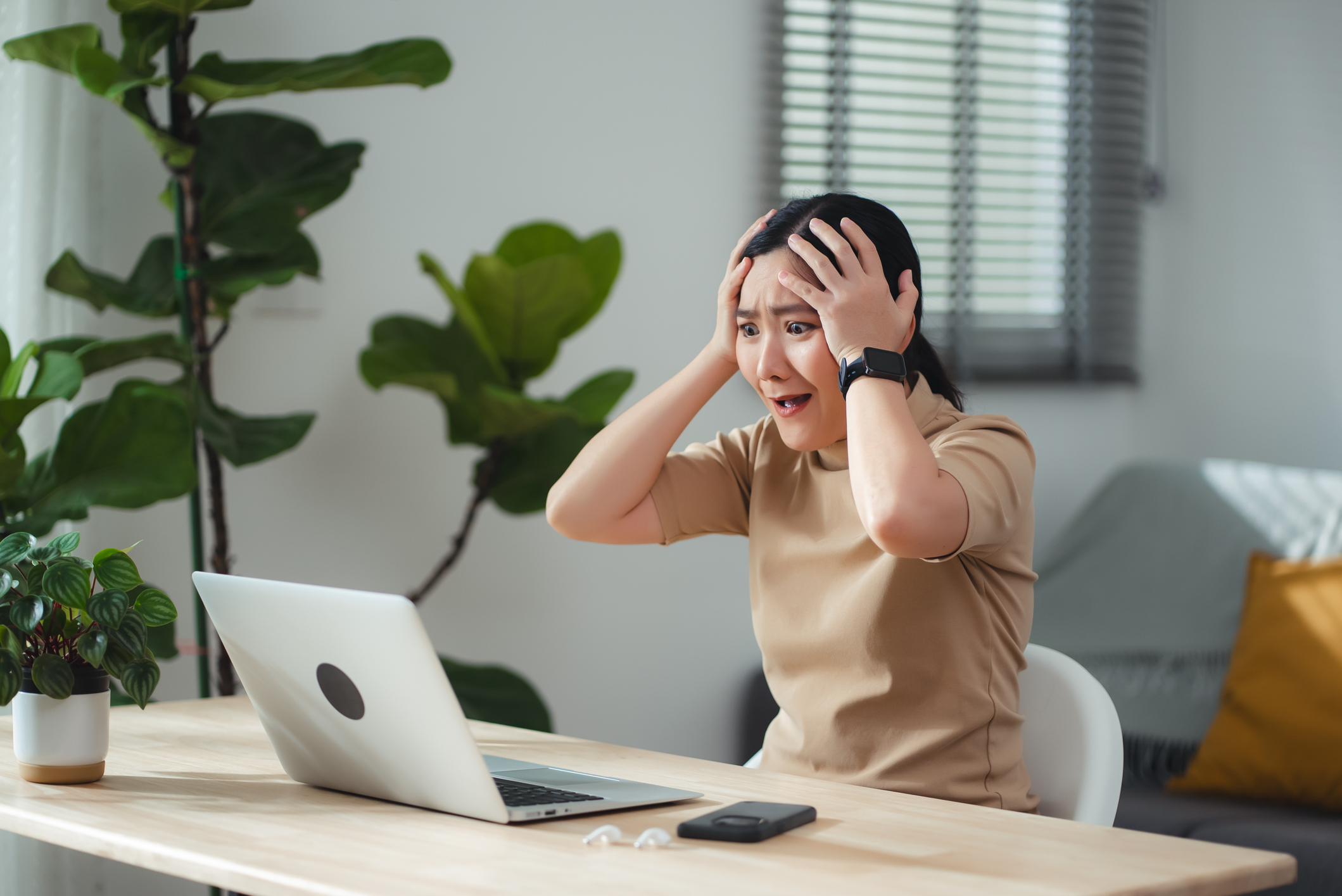 Asian woman sitting at home office thinking about Shopify mistakes