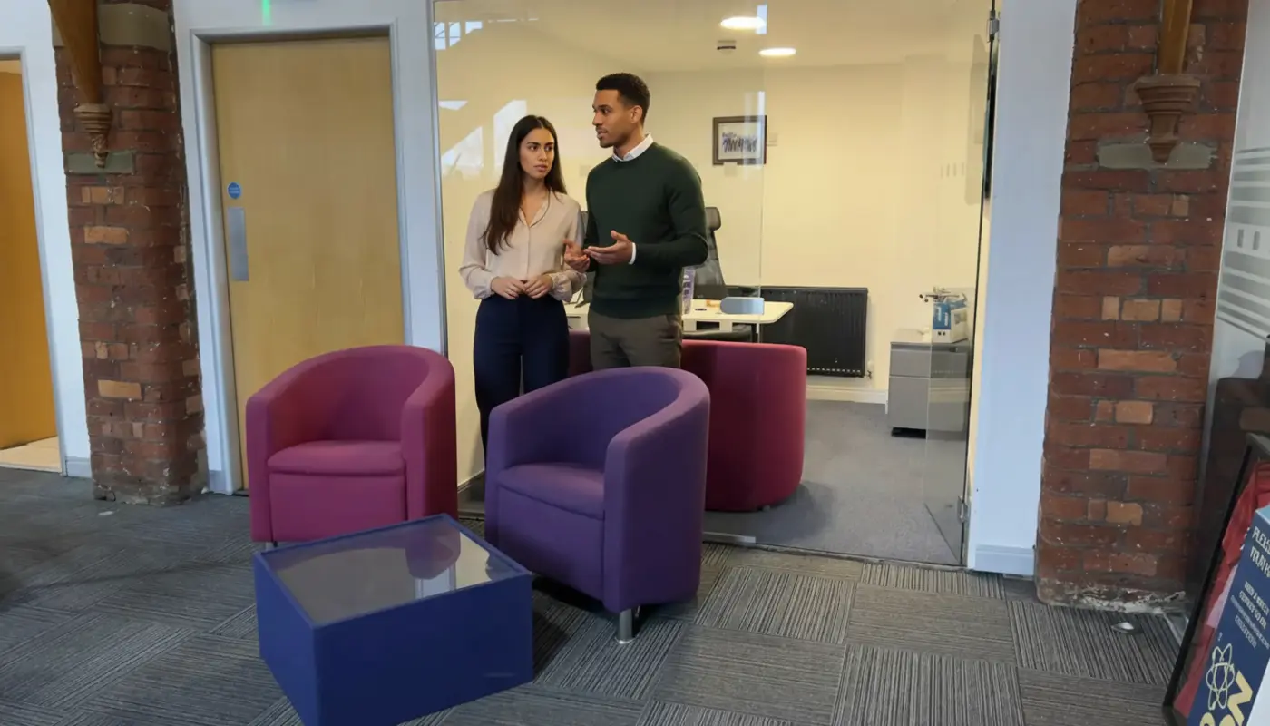 Sara and Zak discussing brand consistency inside a UK creative studio office.