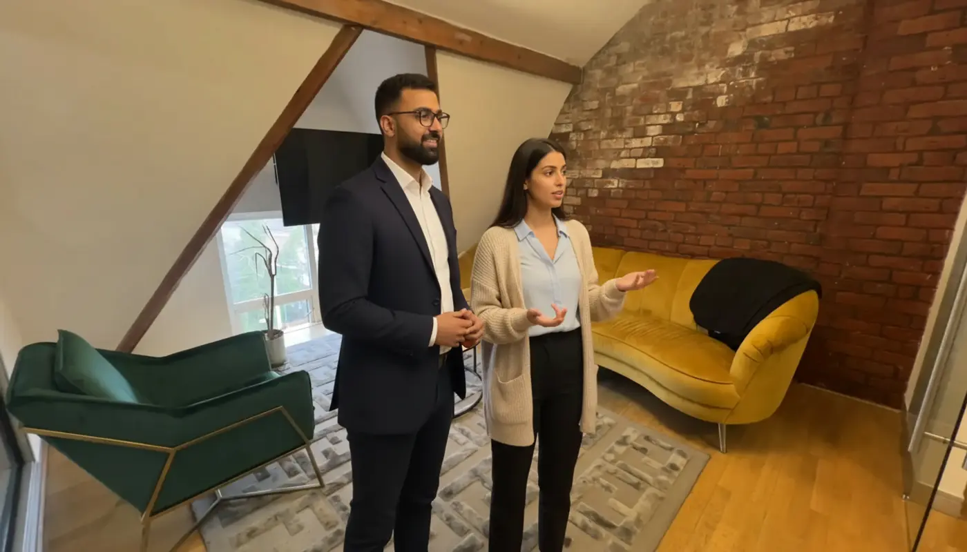 Omer and Sara discussing AI Overview strategy inside a UK office.
