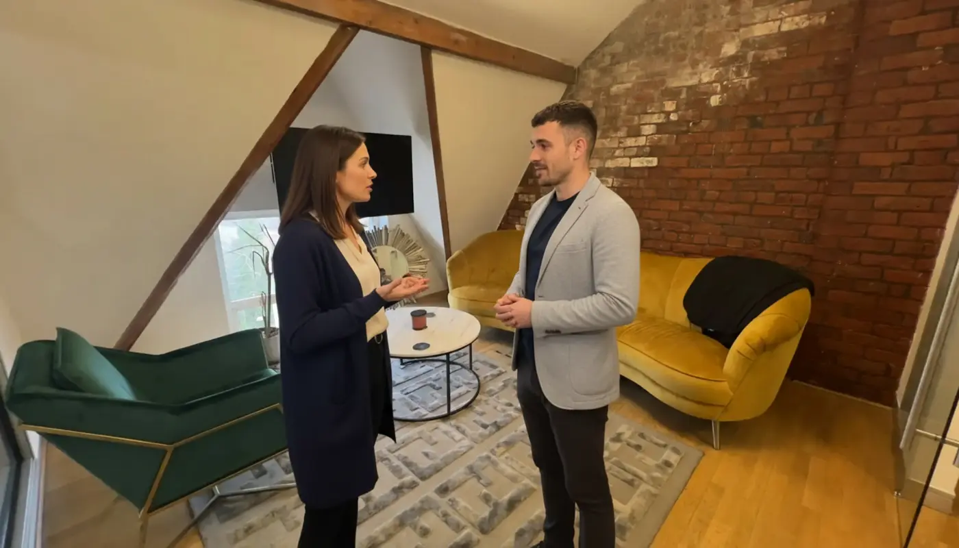 Jessica and Adam discussing ML vs AI inside a UK office.