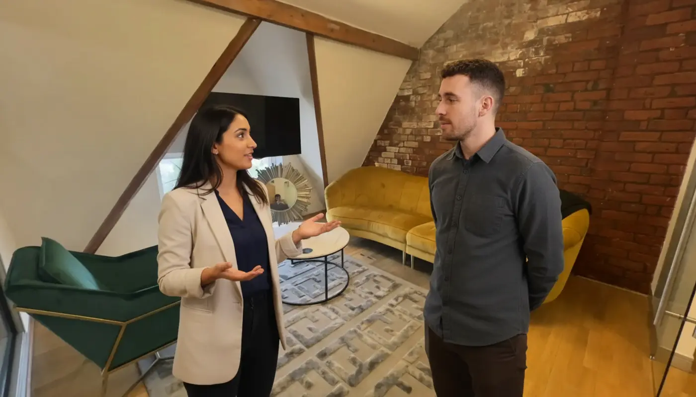 Sara and Adam discussing brand awareness strategy inside a UK office during a natural work moment.