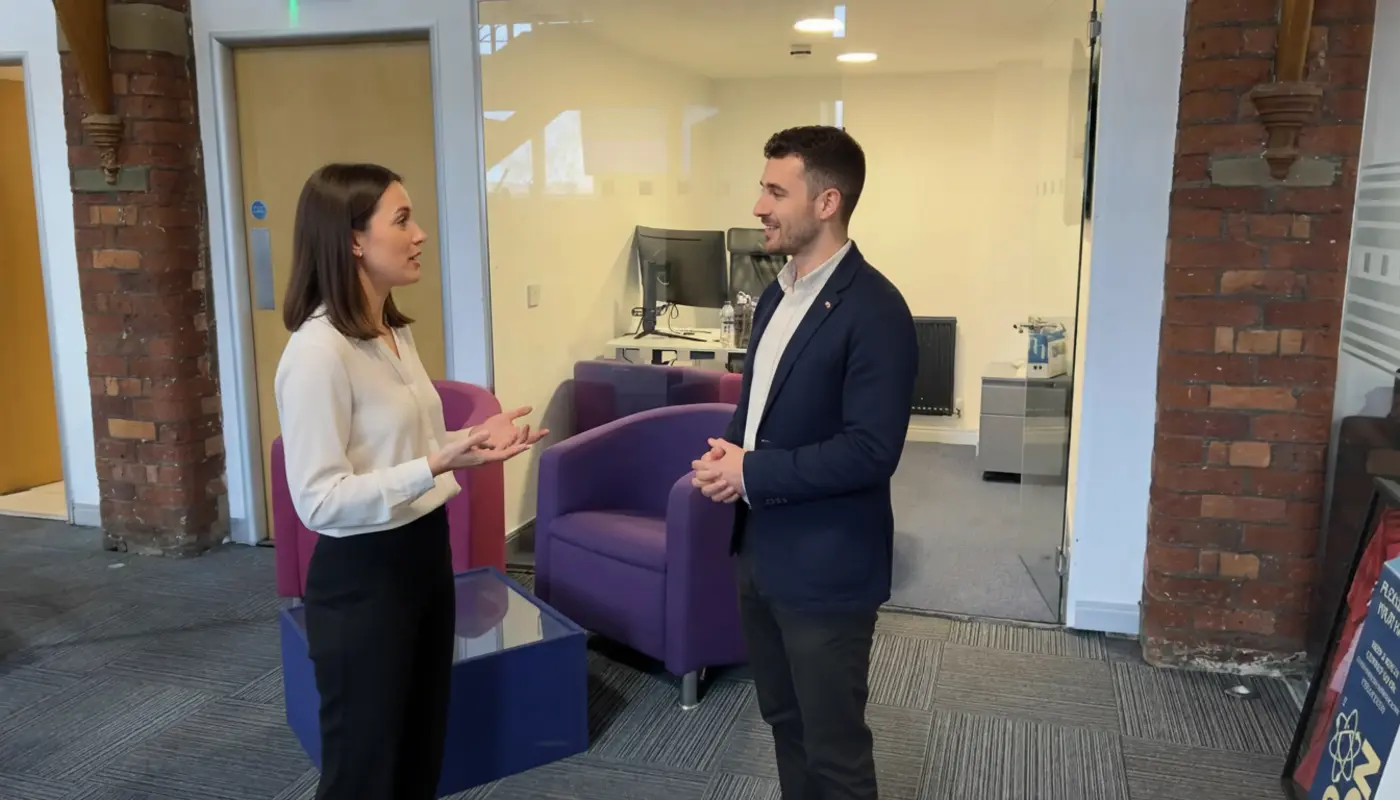 Jessica and Adam discussing digital marketing strategy in a UK office.