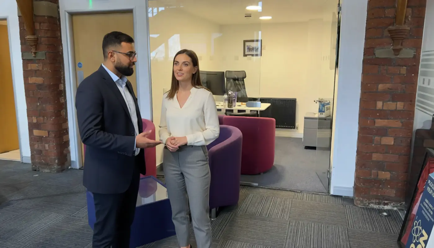 Omar and Jessica discussing SEO strategy inside a UK office, mid-collaboration.