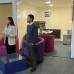 Sara and Zak discussing branding inside a UK office environment.