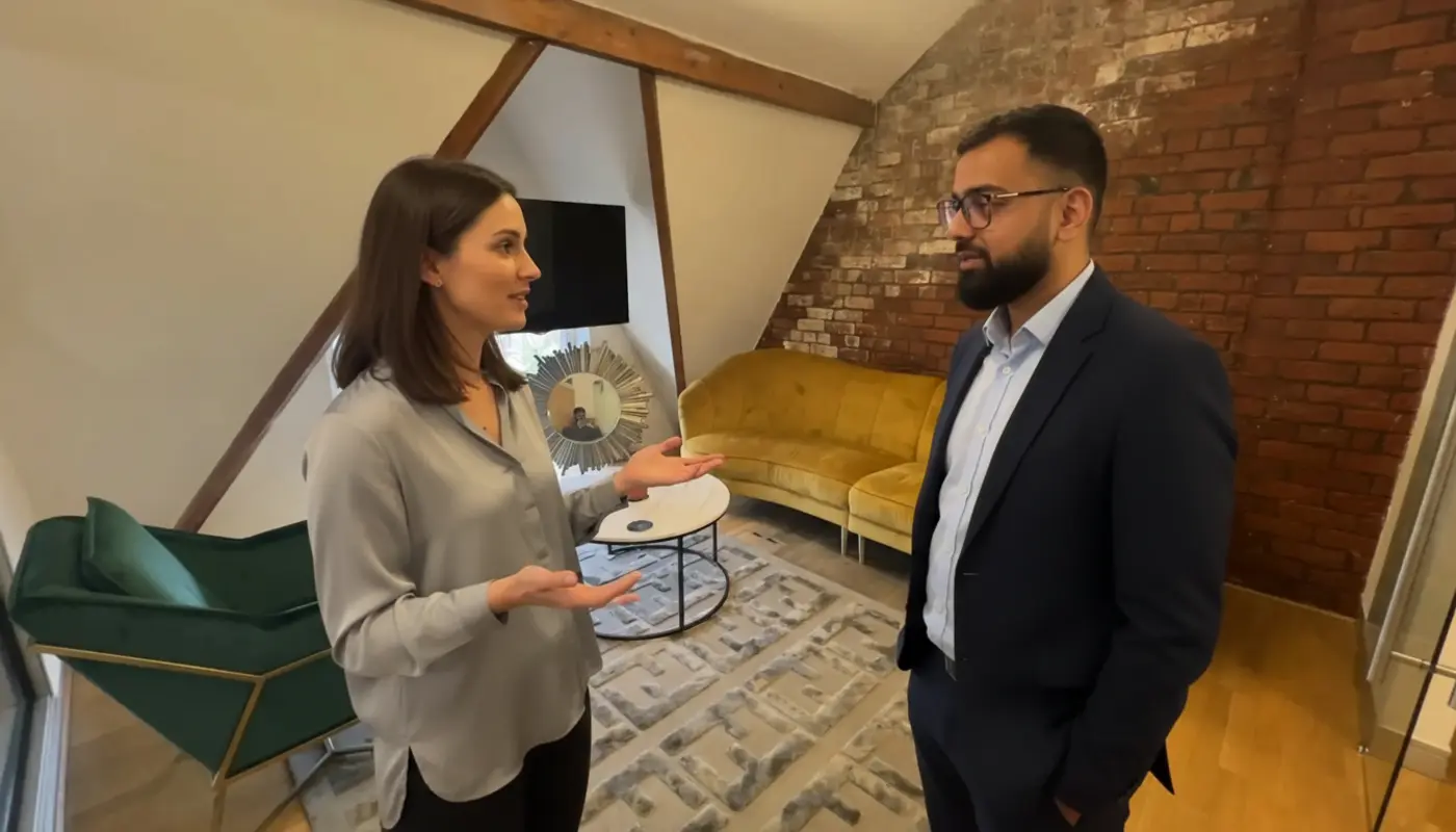 Omer and Jessica discussing AI search strategy inside a UK office, mid-conversation.