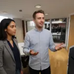 Sara and Adam discussing Microsoft 365 differences inside a UK office environment.