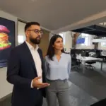 Omer and Sara discussing AdSense payment workflow inside a UK office.