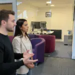 Adam and Sara in a UK ecommerce workspace discussing automation strategy.