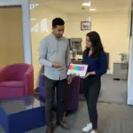 Zak and Sara discussing Shopify shopping behaviour inside a UK office.