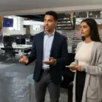 Zak and Sara discussing work together inside a UK office environment.
