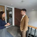 Jessica and Adam discussing ecommerce checkout improvements inside a UK office.