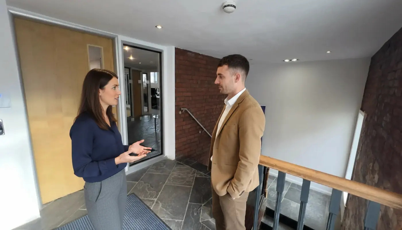 Jessica and Adam discussing ecommerce checkout improvements inside a UK office.